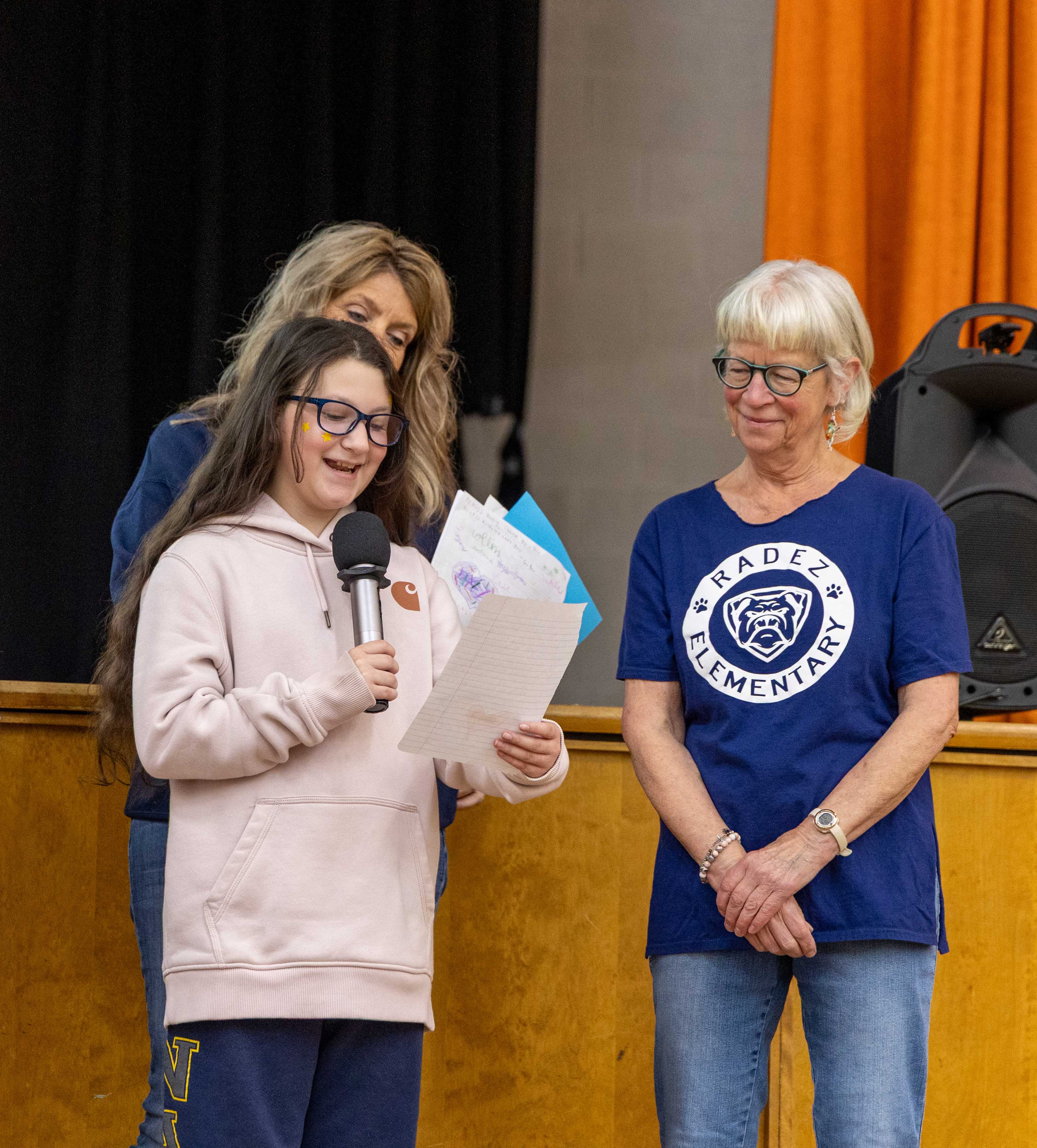 Ms. Patty listens to 5th grader, Gia, say sweet words about her at Radez Rally